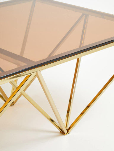 Red-Tinted Tempered Glass Top Coffee Table With Geometric Prismatic Champagne Metal Legs, Allure